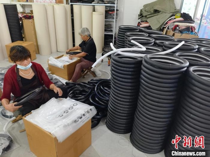 圖為村民在汽車(chē)飾品企業(yè)生產(chǎn)車(chē)間中工作?！巫雍?攝