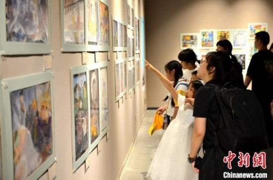 圖為家長帶著孩子參觀展覽。呂明 攝