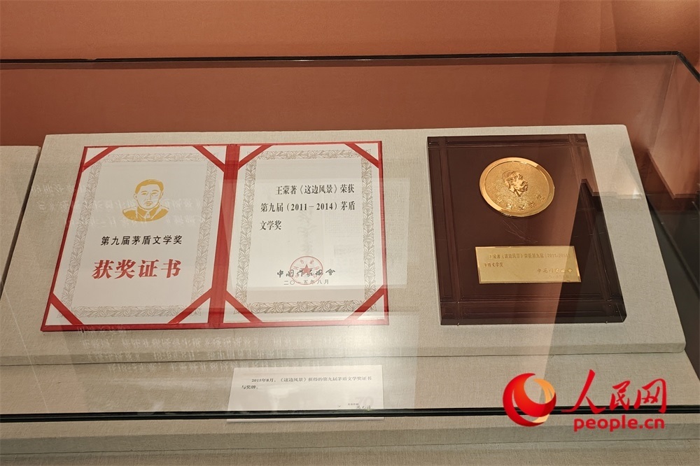 《這邊風景》獲得的第九屆茅盾文學獎證書與獎牌。人民網(wǎng)記者 韋衍行攝