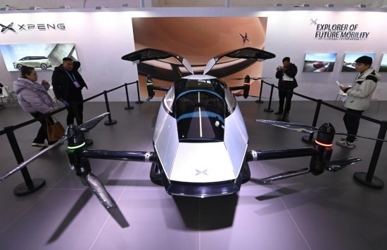 2023年12月1日，在鏈博會(huì)智能汽車鏈展區(qū)小鵬汽車展臺(tái)，參觀者觀看一臺(tái)智能飛行器。新華社記者蔡湘鑫攝