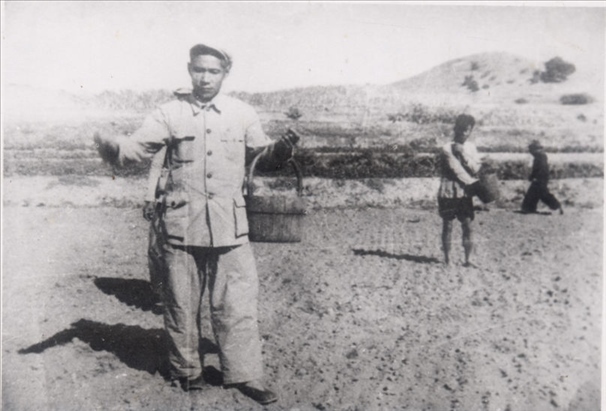 谷文昌（左）在田間與農(nóng)民一起勞動(dòng)（資料照片）。