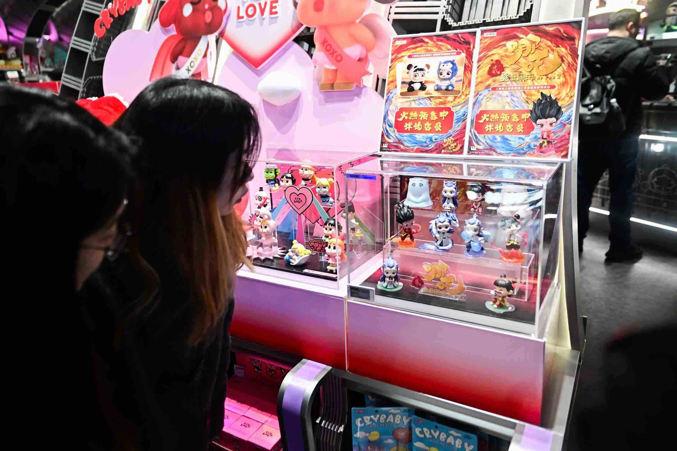 △2025年2月22日，上海，市民在圍觀《哪吒之魔童鬧?！废嚓P(guān)手辦盲盒。